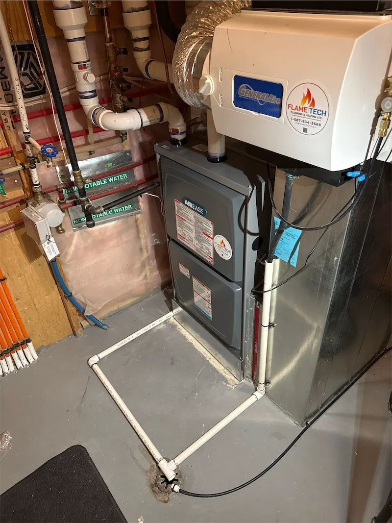 Whole-home humidifier mounted on a high-efficiency furnace, with a FlameTech service sticker