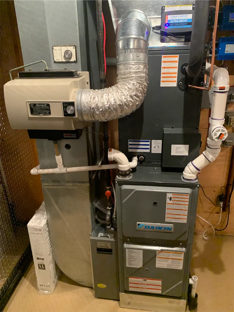 Daikin high-efficiency furnace install by FlameTech with ductwork, humidifier, and UV air treatment in a Calgary basement